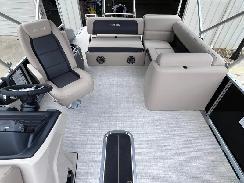 Slide: The Image of 2025 Harris Cruiser 230 boat interior with beige seating and modern steering console. - 20