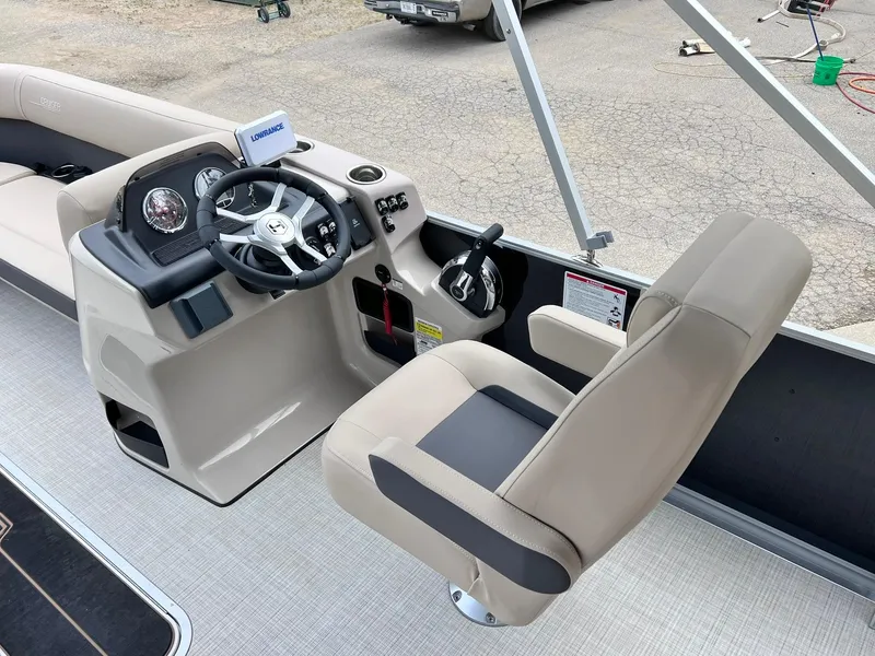 Slide: The Image of 2025 Harris Cruiser 230 boat interior with steering wheel and captain's chair. - 21