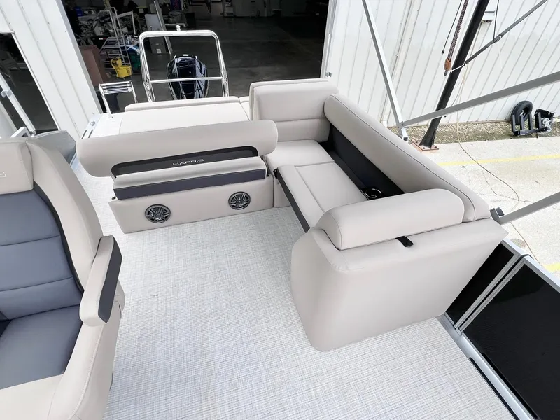 Slide: The Image of 2025 Harris Cruiser 230 boat interior with beige seating and modern design. - 23