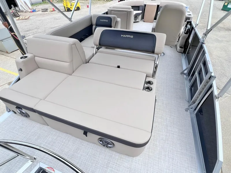 Slide: The Image of 2025 Harris Cruiser 230 pontoon boat interior with beige seating and cup holders. - 24