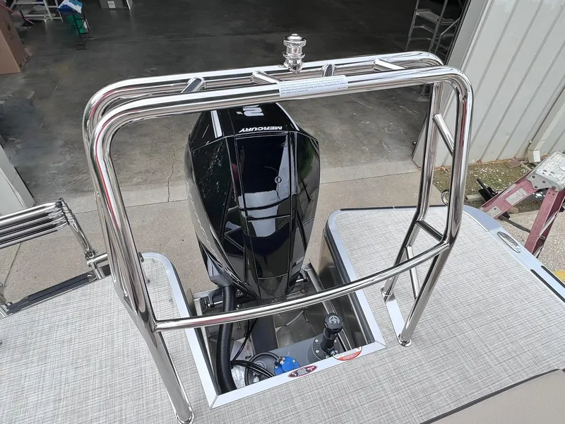 Slide: The Image of 2025 Harris Cruiser 230 boat with Mercury engine, viewed from above in a garage setting. - 26