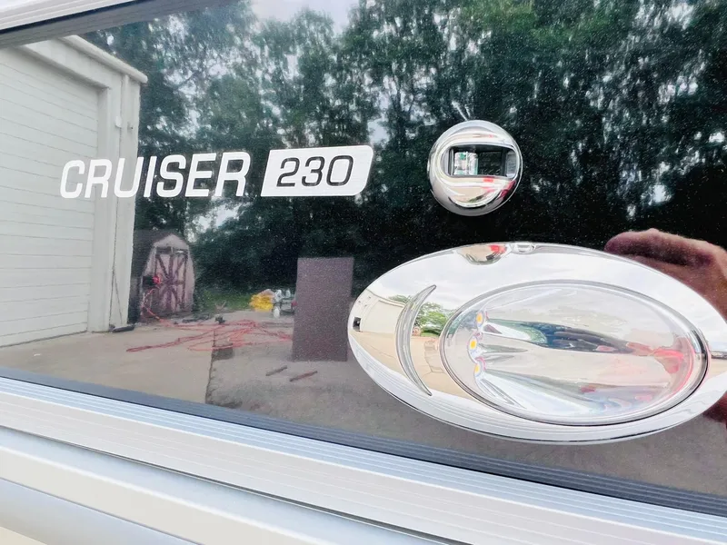 Slide: The Image of 2025 Harris Cruiser 230 boat exterior with logo and chrome details. - 27