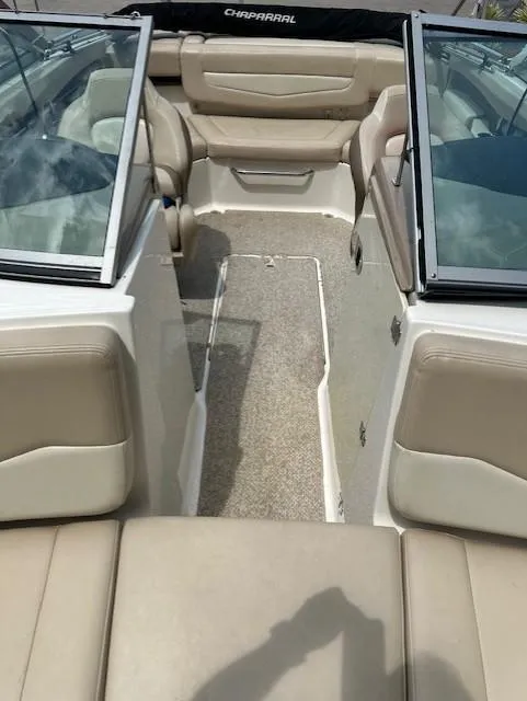 Slide: The Image of 2011 Chaparral 216 SSi boat interior with beige seating and open windshield. - 10
