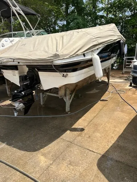 Slide: The Image of 2011 Chaparral 216 SSi boat covered and docked outdoors. - 2