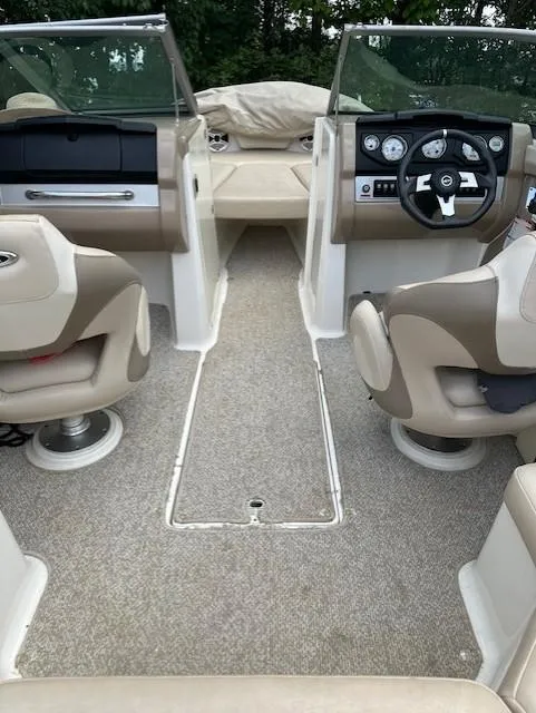 Slide: The Image of Interior of 2011 Chaparral 216 SSi boat with beige seating and dashboard. - 7