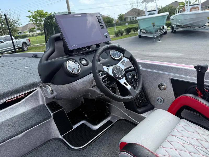 Slide: The Image of Interior of 2026 Phoenix 721 ZXL boat with steering wheel and dashboard display. - 11