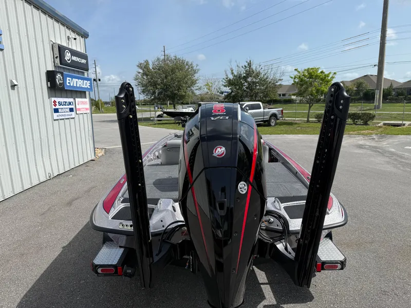 Slide: The Image of 2026 Phoenix 721 ZXL boat with powerful engine, parked outdoors near dealership signs. - 15