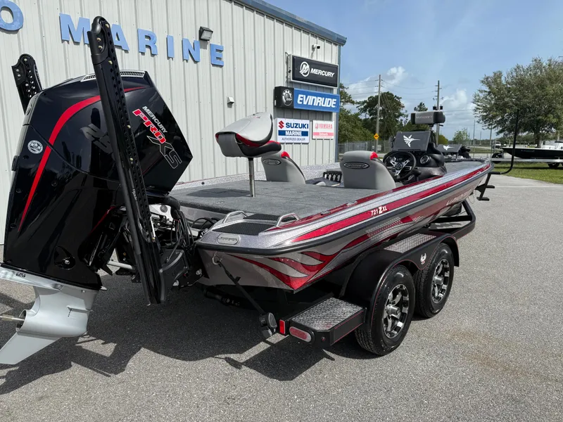 Slide: The Image of 2026 Phoenix 721 ZXL boat with dual axle trailer, parked outside a marine dealership. - 16