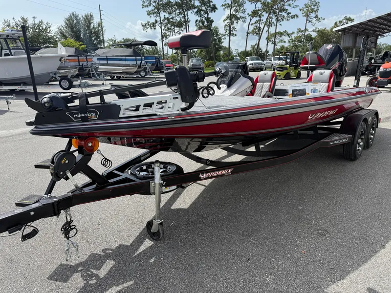Slide: The Image of 2026 Phoenix 721 ZXL boat on trailer, red and black design, parked outdoors. - 3
