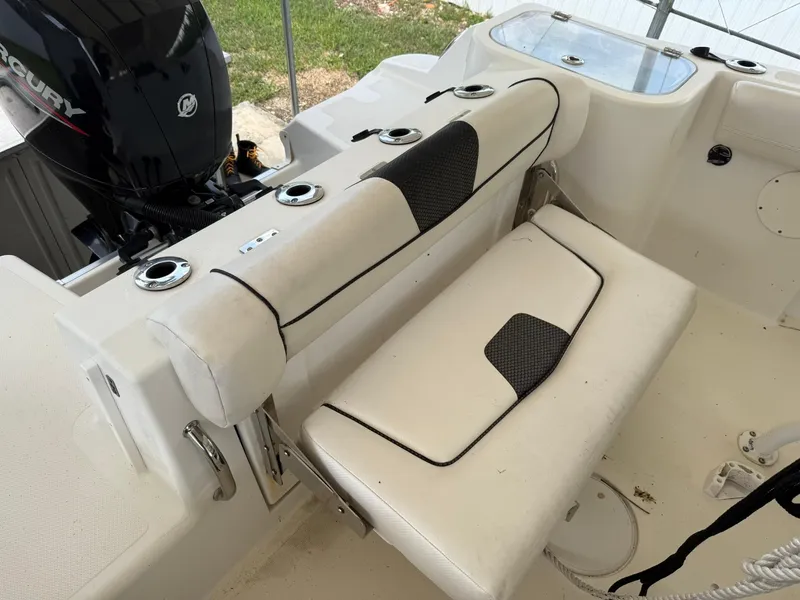 Slide: The Image of 2020 Wellcraft 222 Fisherman boat interior with cushioned seating and Mercury engine. - 10