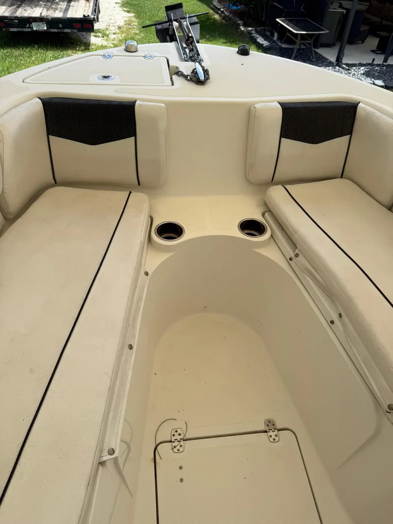 Slide: The Image of 2020 Wellcraft 222 Fisherman boat interior with cushioned seating and cup holders. - 11