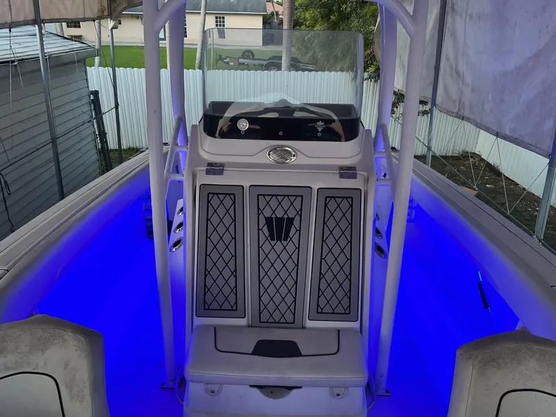 Slide: The Image of 2020 Wellcraft 222 Fisherman boat with illuminated blue deck lighting. - 14