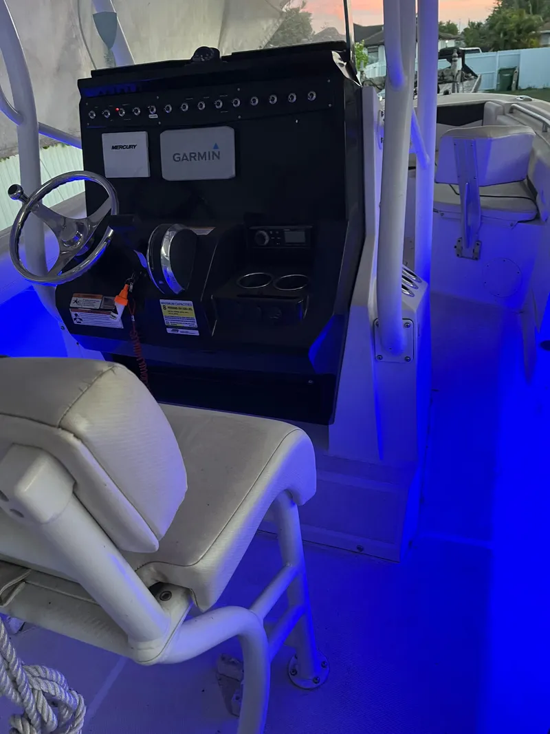 Slide: The Image of 2020 Wellcraft 222 Fisherman boat interior with illuminated dashboard and Garmin equipment. - 15