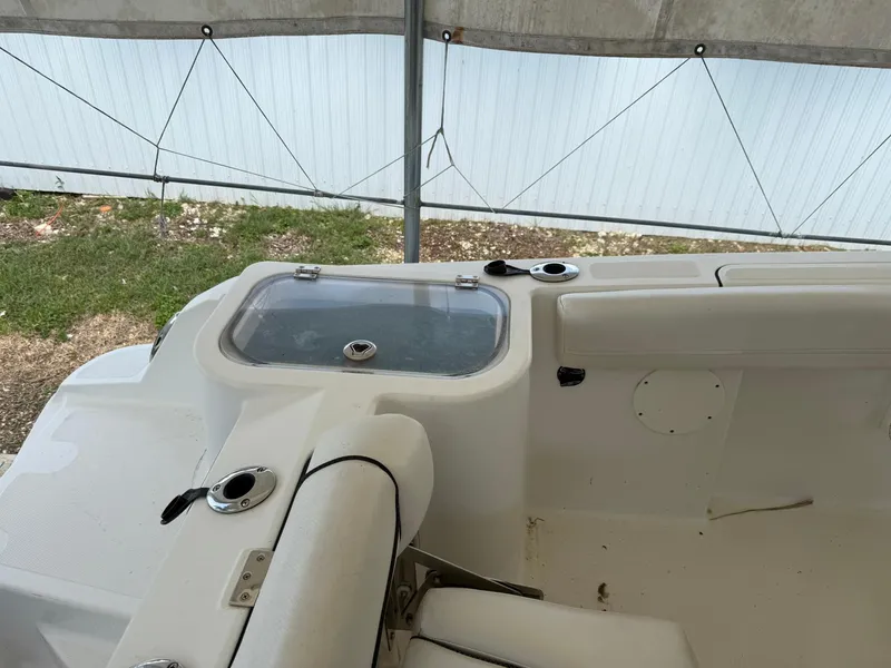 Slide: The Image of 2020 Wellcraft 222 Fisherman boat interior with seating and storage under a canopy. - 16