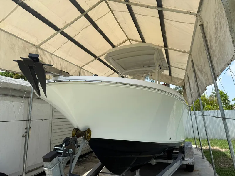 Slide: The Image of 2020 Wellcraft 222 Fisherman boat on trailer under canopy. - 2