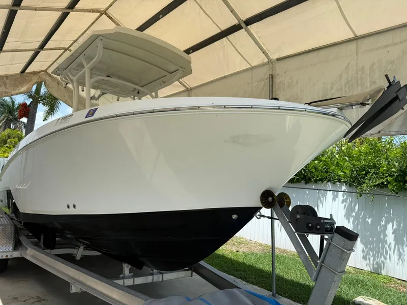 Slide: The Image of 2020 Wellcraft 222 Fisherman boat on trailer under canopy. - 3