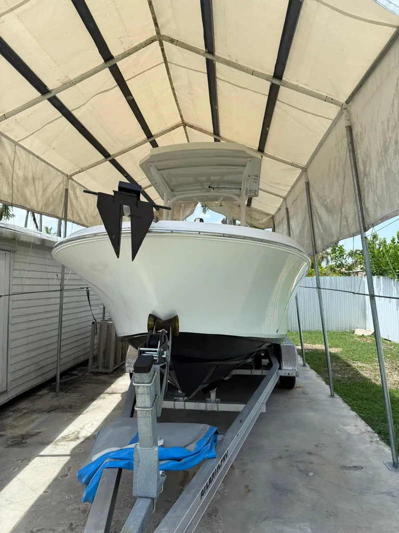 Slide: The Image of 2020 Wellcraft 222 Fisherman boat on trailer under canopy. - 4