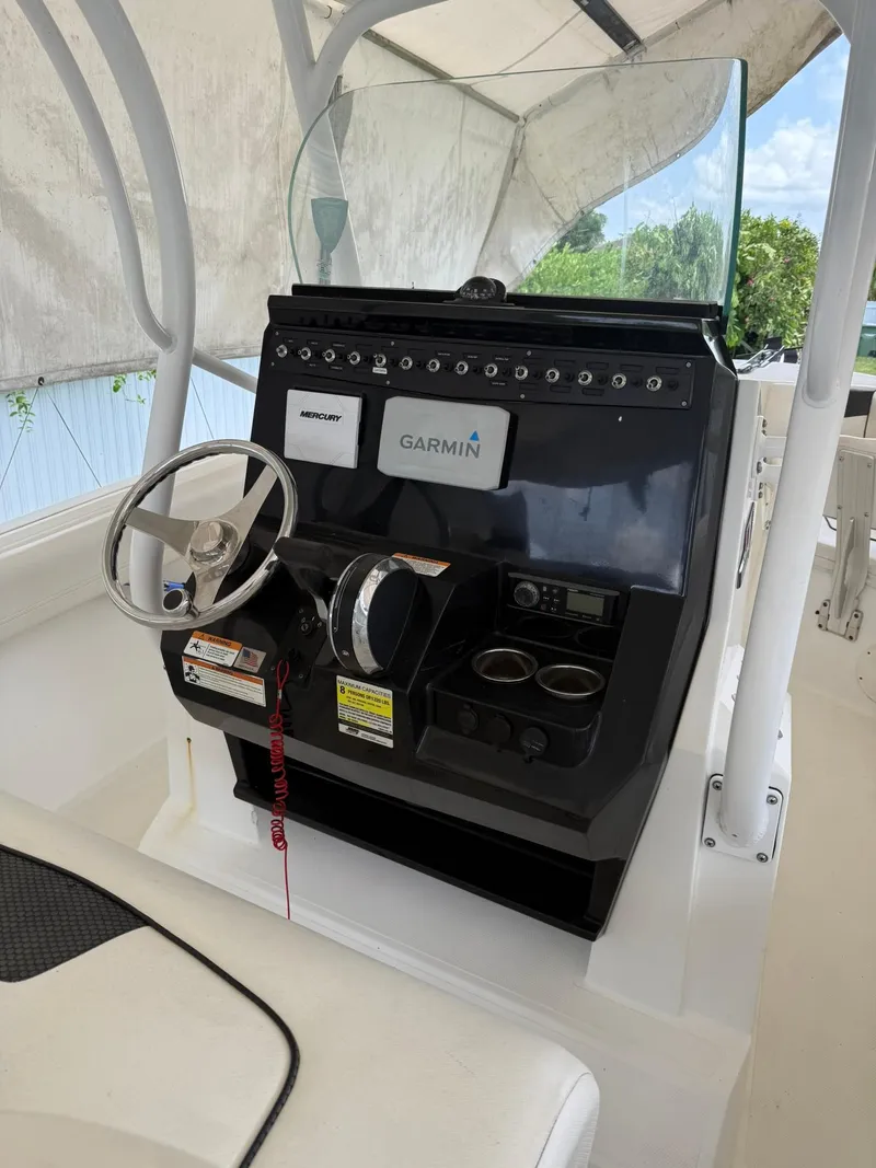 Slide: The Image of 2020 Wellcraft 222 Fisherman boat console with Garmin navigation system and steering wheel. - 7