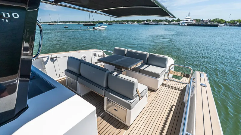 Slide: The Image of 2023 Pardo Yachts P38 deck with seating area on calm water. - 18