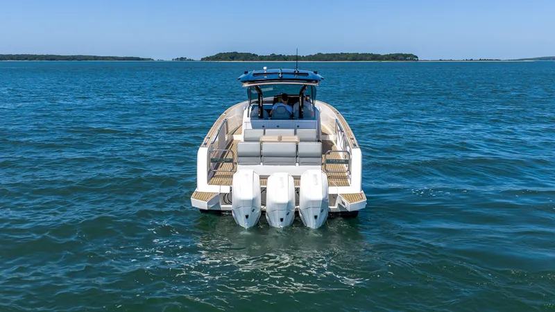 Slide: The Image of 2023 Pardo Yachts P38 cruising on open water, rear view with triple engines. - 2