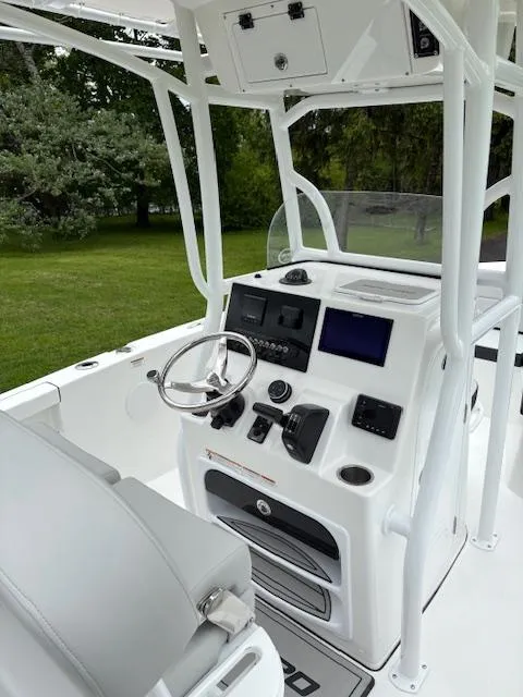 Slide: The Image of 2025 Sea Pro 225 Sandbar boat console with steering wheel and navigation controls. - 10