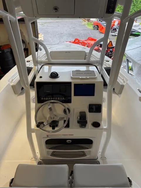 Slide: The Image of 2025 Sea Pro 225 Sandbar boat console with steering wheel and navigation controls. - 12