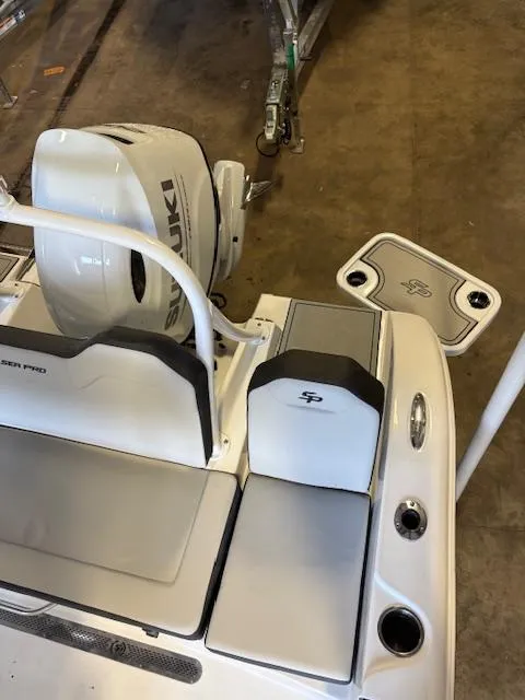 Slide: The Image of 2025 Sea Pro 225 Sandbar boat with Suzuki engine, featuring sleek seating and deck design. - 14
