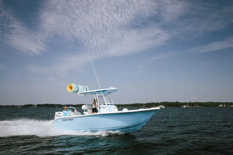 Slide: The Image of 2025 Sea Pro 225 Sandbar boat cruising on open water under a clear sky. - 16