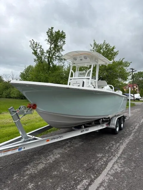 The Image of 2025 Sea Pro 225 Sandbar boat on trailer, parked on a road with greenery. - 7