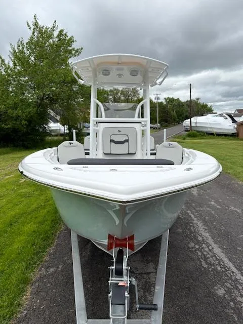 Slide: The Image of 2025 Sea Pro 225 Sandbar boat on trailer, parked on a driveway with cloudy sky. - 9