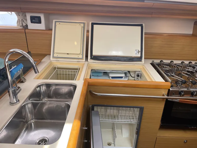 Slide: The Image of Galley of 2008 Jeanneau Sun Odyssey 45 DS with sink, stove, and storage compartments. - 45