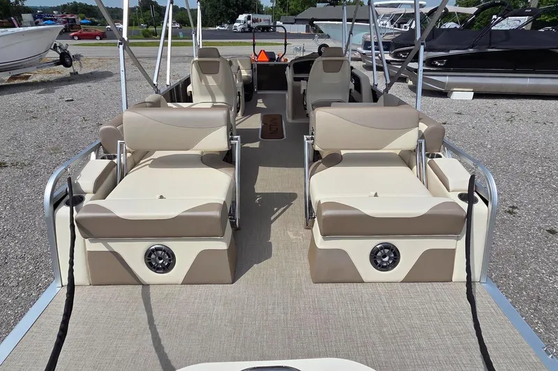 Slide: The Image of 2025 Avalon Platinum LSZ 2385 Cruise Rear Bench pontoon boat with beige seating and spacious layout. - 10