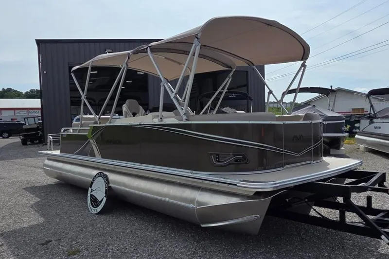 Slide: The Image of 2025 Avalon Platinum LSZ 2385 Cruise Rear Bench pontoon boat with canopy, parked outdoors. - 11
