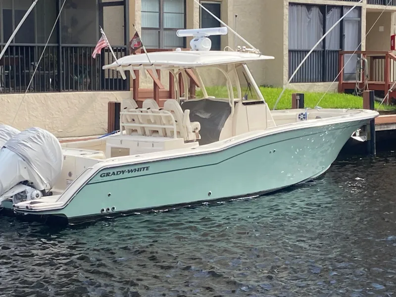 Slide: The Image of 2024 Grady-White Canyon 326 boat docked in a marina, side view. - 4