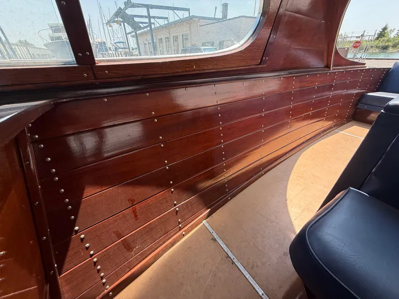 Slide: The Image of Interior of a 1950 Chris-Craft 22' Custom Sedan with polished wood paneling. - 11