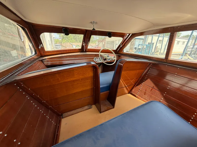 Slide: The Image of 1950 Chris-Craft 22' Custom Sedan interior with wooden panels and blue seating. - 4