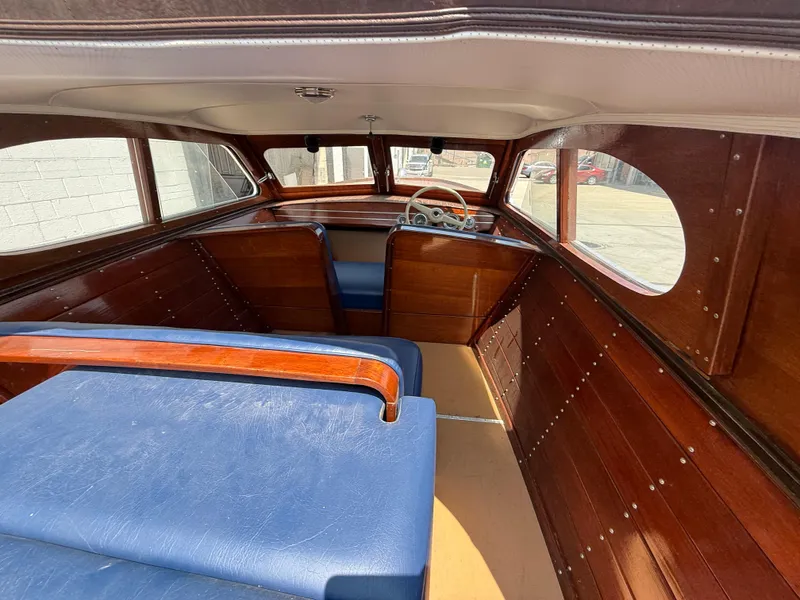 Slide: The Image of Interior of 1950 Chris-Craft 22' Custom Sedan with wooden panels and blue seating. - 5