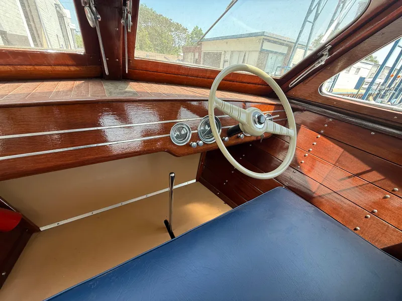 Slide: The Image of Interior of a 1950 Chris-Craft 22' Custom Sedan with wooden dashboard and vintage steering wheel. - 6