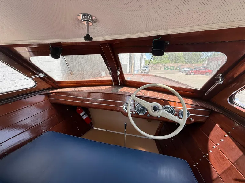 Slide: The Image of 1950 Chris-Craft 22' Custom Sedan interior with wooden dashboard and classic steering wheel. - 7
