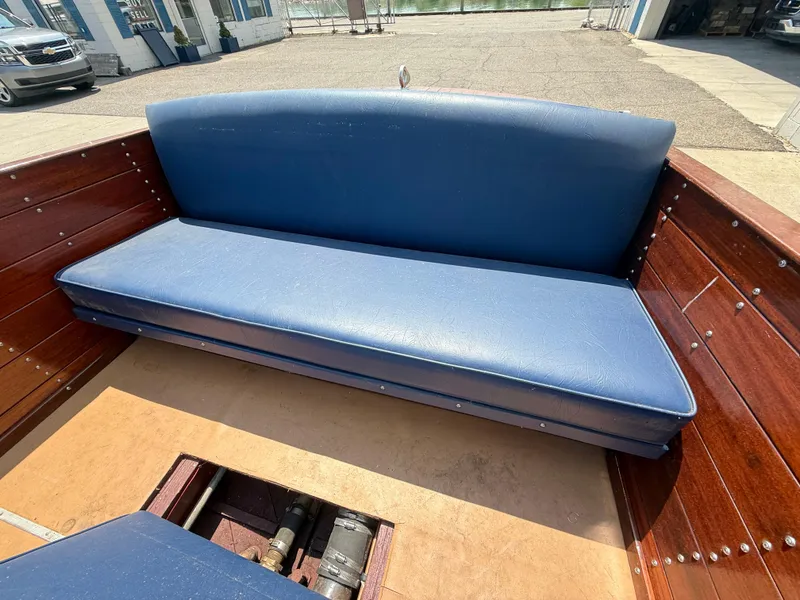 Slide: The Image of 1950 Chris-Craft 22' Custom Sedan interior with blue seating and wooden details. - 8