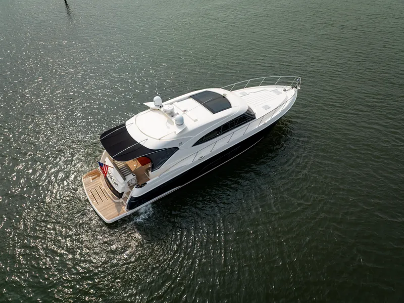Slide: The Image of 2018 Riviera 5400 Sport Yacht cruising on calm waters, aerial view. - 10