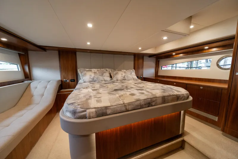 Slide: The Image of Luxurious bedroom interior of 2018 Riviera 5400 Sport Yacht with elegant wood finishes. - 21