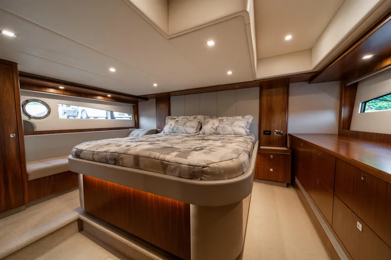 Slide: The Image of Luxurious bedroom interior of 2018 Riviera 5400 Sport Yacht with elegant wood finishes. - 22
