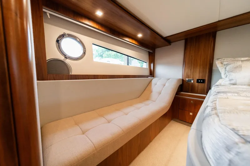 Slide: The Image of Luxurious interior of 2018 Riviera 5400 Sport Yacht with elegant wood and plush seating. - 24