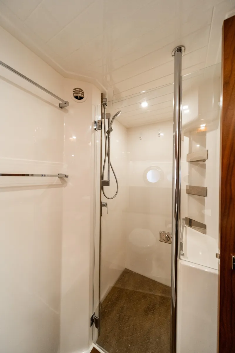 Slide: The Image of 2018 Riviera 5400 Sport Yacht shower with modern fixtures and sleek design. - 26