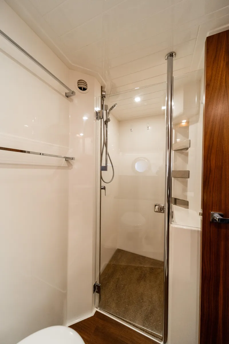 Slide: The Image of 2018 Riviera 5400 Sport Yacht bathroom with modern shower and sleek design. - 27