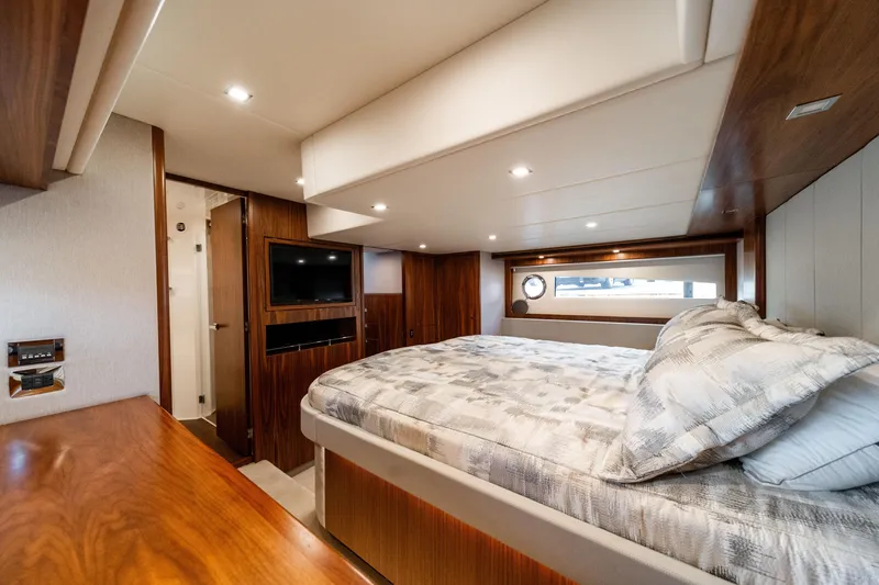 Slide: The Image of Luxurious bedroom interior of 2018 Riviera 5400 Sport Yacht with modern amenities and elegant design. - 29