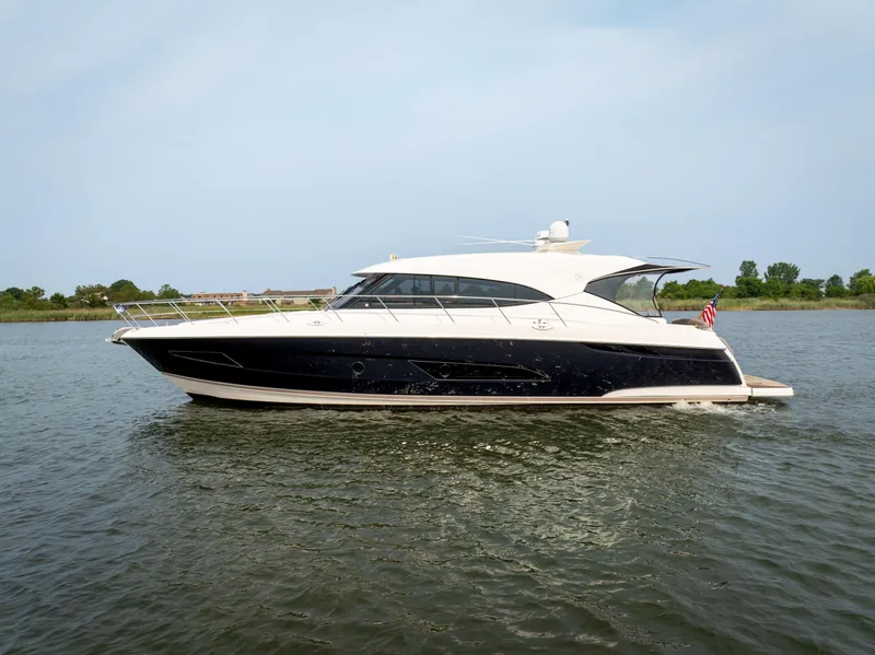 Slide: The Image of 2018 Riviera 5400 Sport Yacht cruising on calm waters. - 3