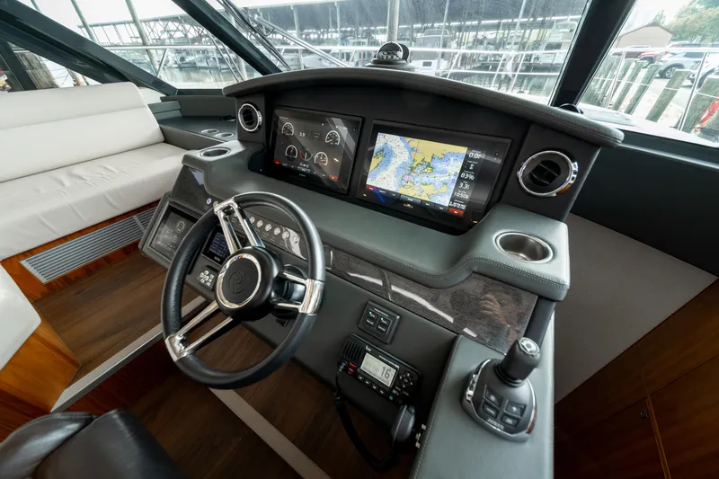 Slide: The Image of Helm of 2018 Riviera 5400 Sport Yacht with navigation screens and controls. - 32