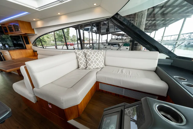 Slide: The Image of Luxurious interior of 2018 Riviera 5400 Sport Yacht with elegant white seating and scenic window view. - 33